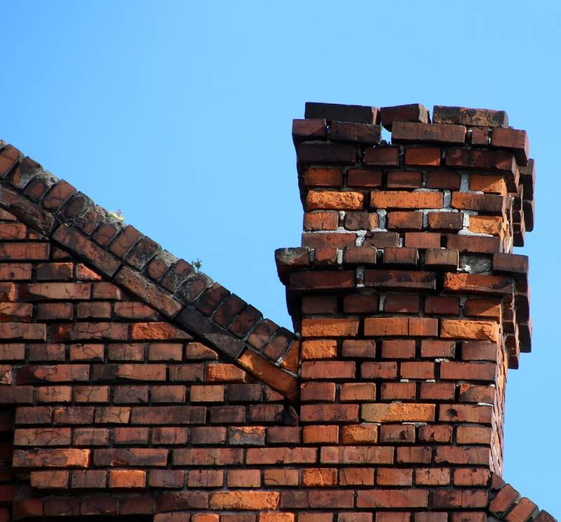 Signs Your Keego Harbor Home Needs a Chimney Inspection Damaged chimney on an Keego Harbor home showing cracks and missing mortar